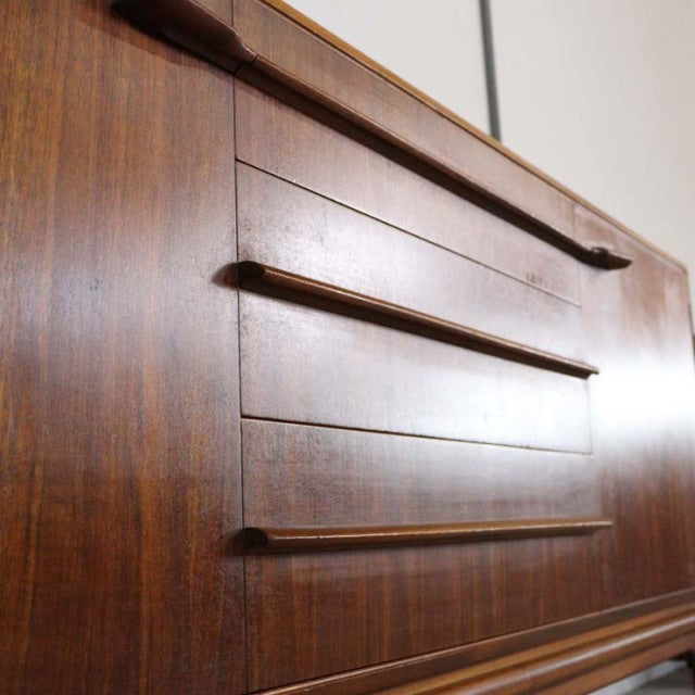 Vintage British mid-century teak sideboard by A.H. McIntosh with rich wood grain and sleek horizontal drawer handles.
