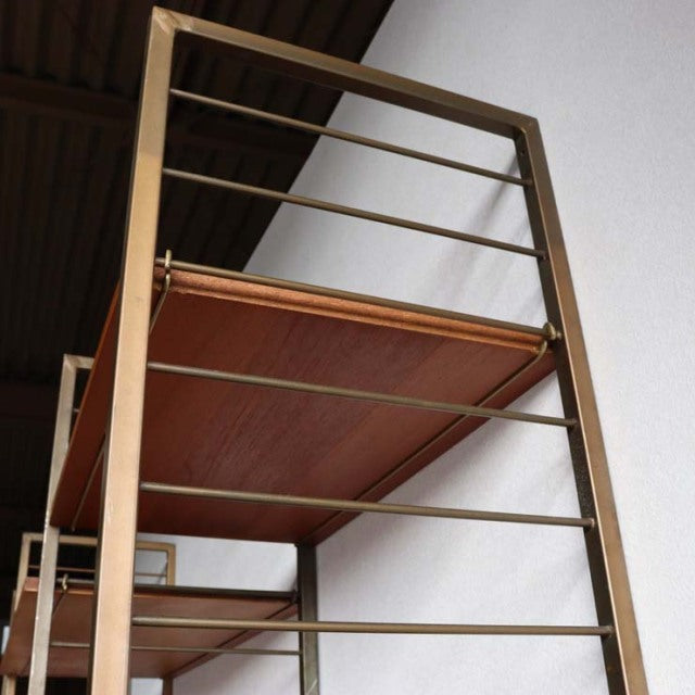 Vintage teak Ladderax shelving unit by Staples, British mid-century design with metal frame and wood grain shelves, slim legs.