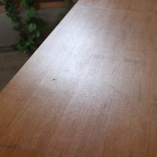 Vintage British mid-century teak sideboard top surface showing natural wood grain and smooth finish.