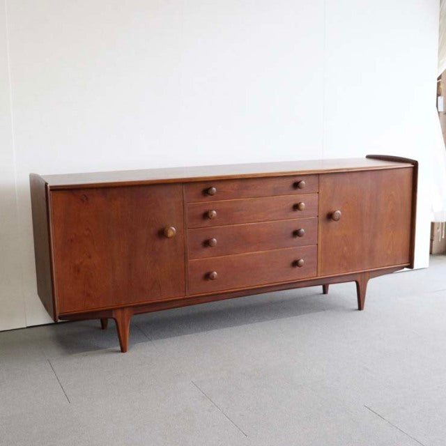 Vintage mid-century teak sideboard by Younger with British-Denmark design, featuring four central drawers, round wooden.