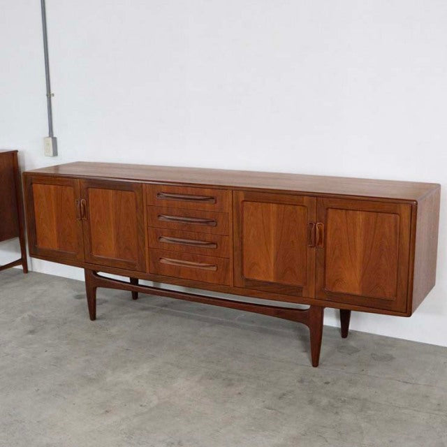 Mid-century British G-Plan Fresco sideboard in vintage teak with rich wood grain, tapered legs, central drawers, and side.