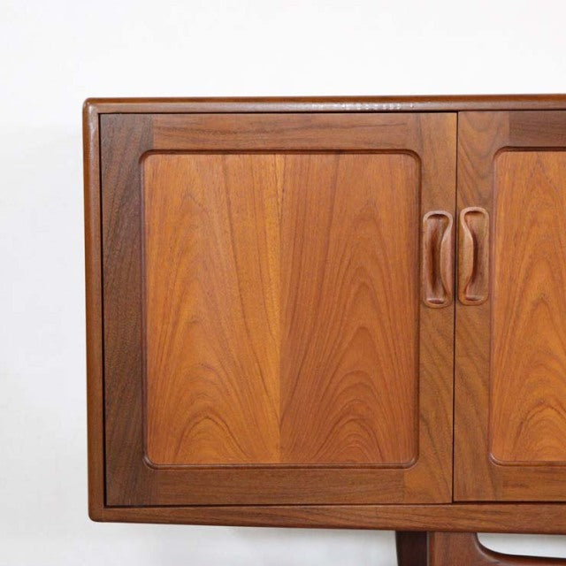 Vintage British mid-century G-Plan Fresco teak sideboard door with smooth wood grain and rounded handles.