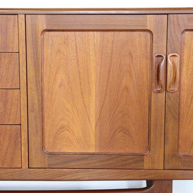 Mid-century British vintage G-Plan Fresco teak sideboard door with curved edges and visible wood grain.