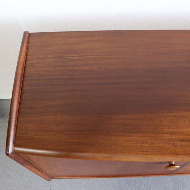 Vintage teak sideboard top with smooth grain, mid-century British design, clean edges, warm tone.