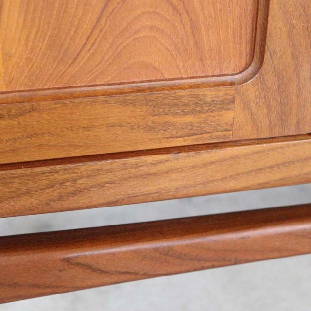 Close-up of vintage teak wood grain on mid-century British G-Plan Fresco sideboard with smooth rounded edges and polished.