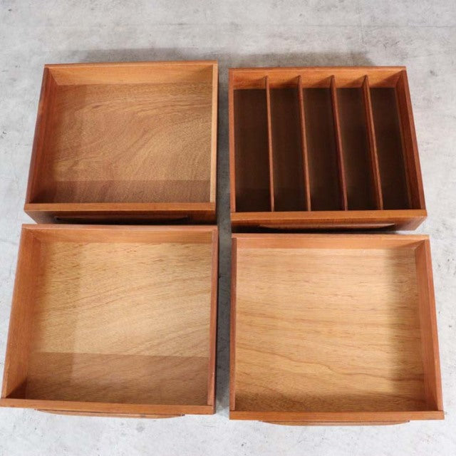 Set of four vintage teak drawers with visible wood grain, mid-century British design by G-PLAN, featuring clean lines and.