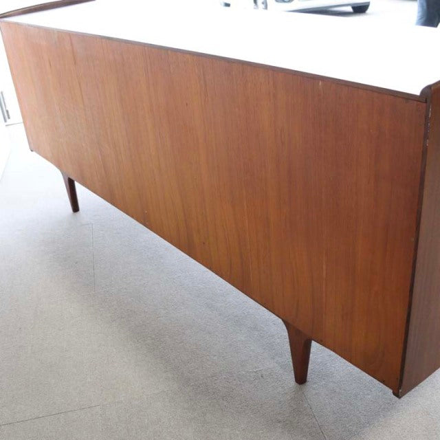 Mid-century vintage teak sideboard from British-Danish YOUNGER with sleek wood grain and tapered legs.