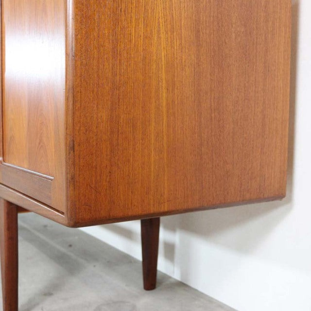 Vintage teak G-Plan Fresco sideboard corner showing wood grain and tapered mid-century British legs.