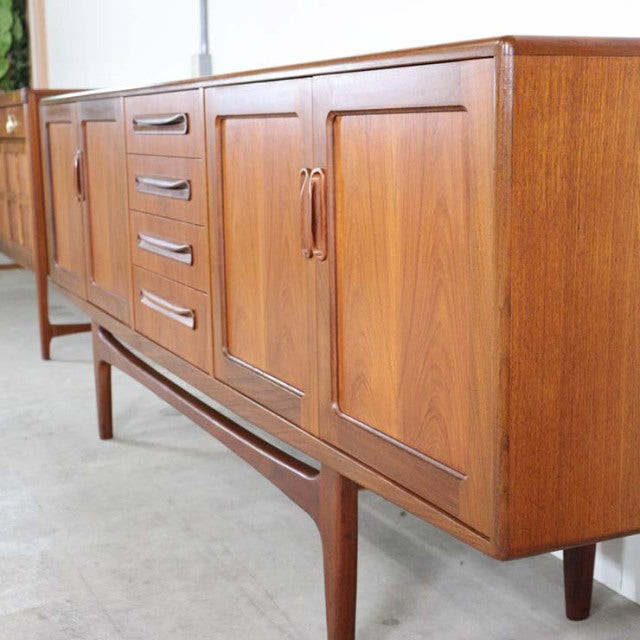 Mid-century British G-Plan Fresco sideboard in teak with rich wood grain, tapered legs, and sleek recessed handles.
