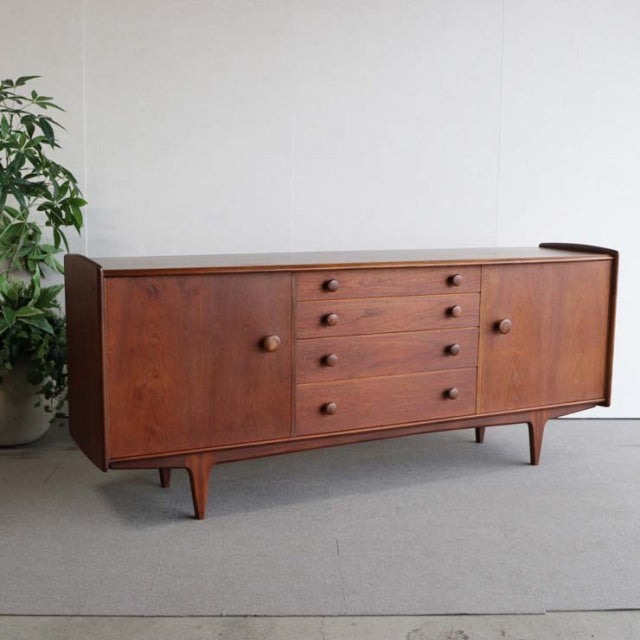 Vintage teak sideboard by Younger, British mid-century design with rounded edges and tapered legs from Denmark.