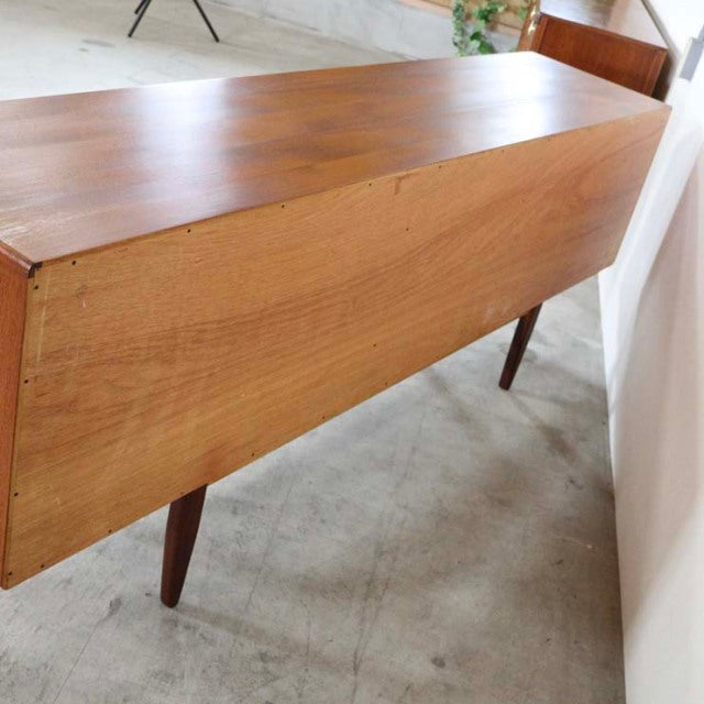 G-plan mid-century British vintage teak sideboard with clean lines and tapered legs, rich wood grain visible on long John.