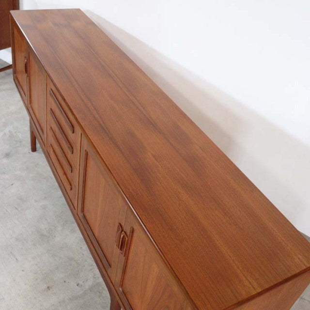 Long British mid-century G-Plan Fresco teak sideboard with rich wood grain, tapered legs, and clean lines.