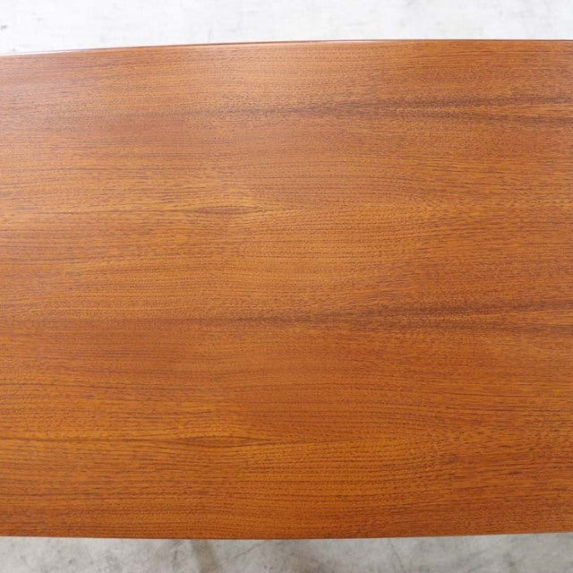 Vintage British mid-century teak sideboard top with warm wood grain and smooth finish.