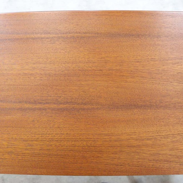 Vintage British mid-century teak sideboard top surface showing smooth wood grain and warm natural finish.