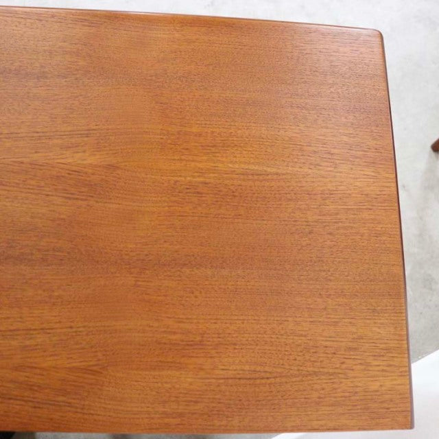 Top view of vintage British mid-century teak sideboard showcasing smooth wood grain and warm honey finish.