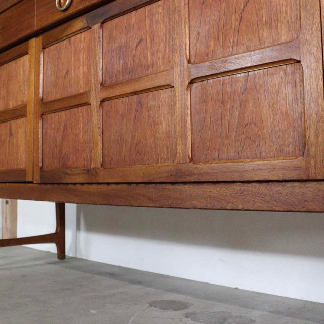 Mid-century British vintage teak sideboard by Nathan with geometric wood grain panels and tapered legs.