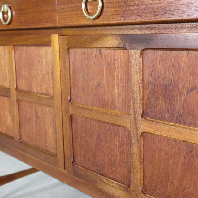 Close-up of British mid-century vintage teak sideboard by Nathan featuring rich wood grain, panel detailing, and sleek.
