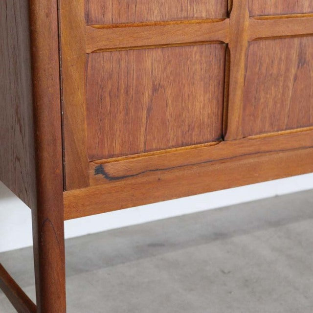 Mid-century British vintage teak sideboard by Nathan with rich wood grain and raised panel doors, slender legs and warm.