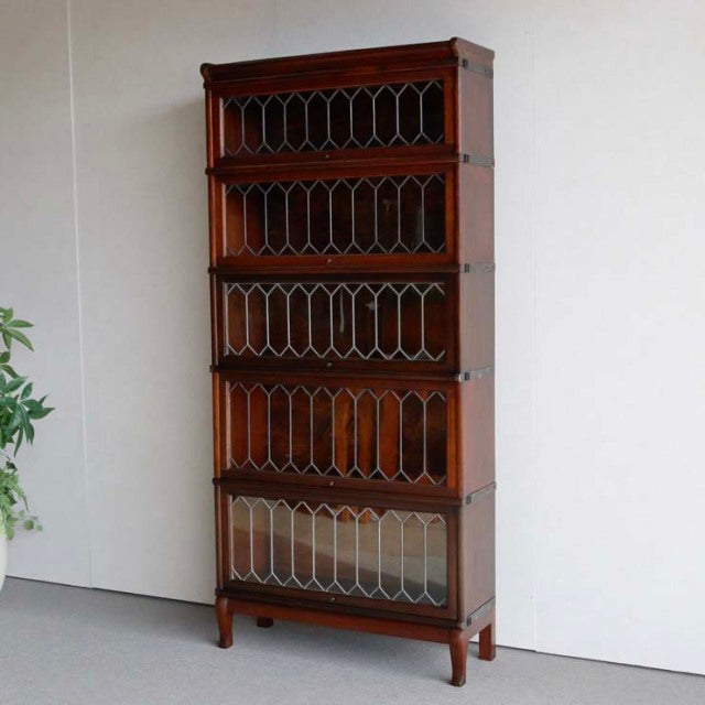 Vintage teak Globe Wernicke glass bookcase with mid-century British design, multiple stacking compartments, intricate wood.
