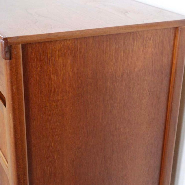 Vintage British teak sideboard with smooth wood grain, clean lines, and slender tapered legs, mid-century design from.