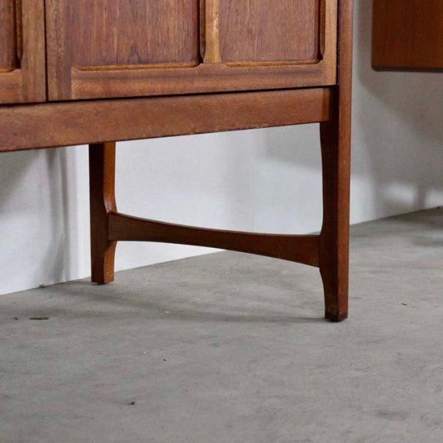 Mid-century British teak sideboard leg with rich wood grain and sleek tapered design, vintage Denmark style.