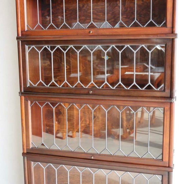 Vintage teak Globe Wernicke glass bookcase with four stackable sections, British mid-century design, geometric leaded glass.