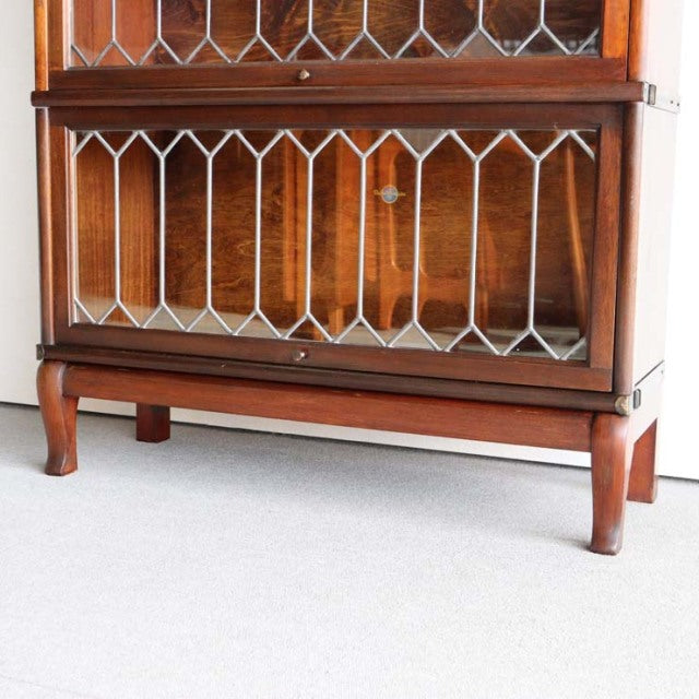 Vintage teak Globe Wernicke British mid-century glass bookcase with geometric leaded glass and carved cabriole legs.