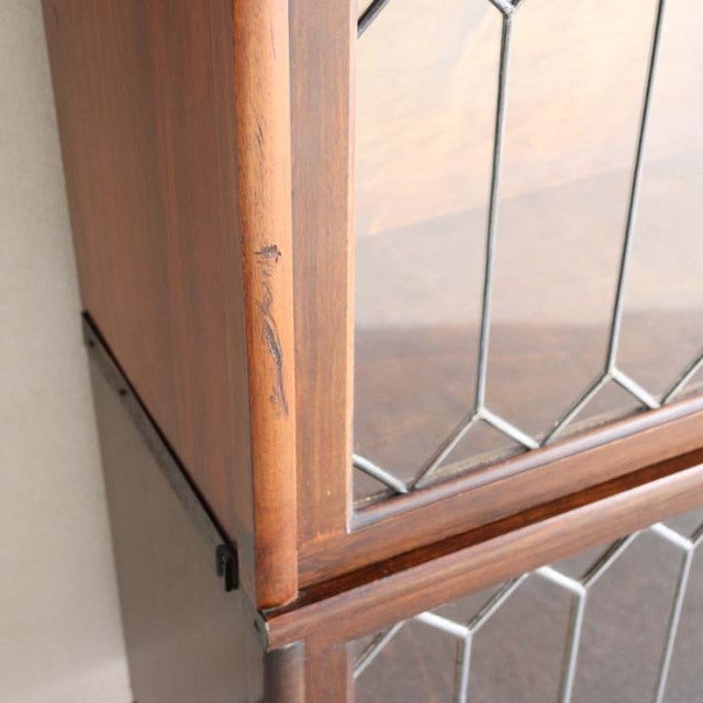 Vintage teak Globe Wernicke glass bookcase with British mid-century design, detailed wood grain and geometric glass panes.