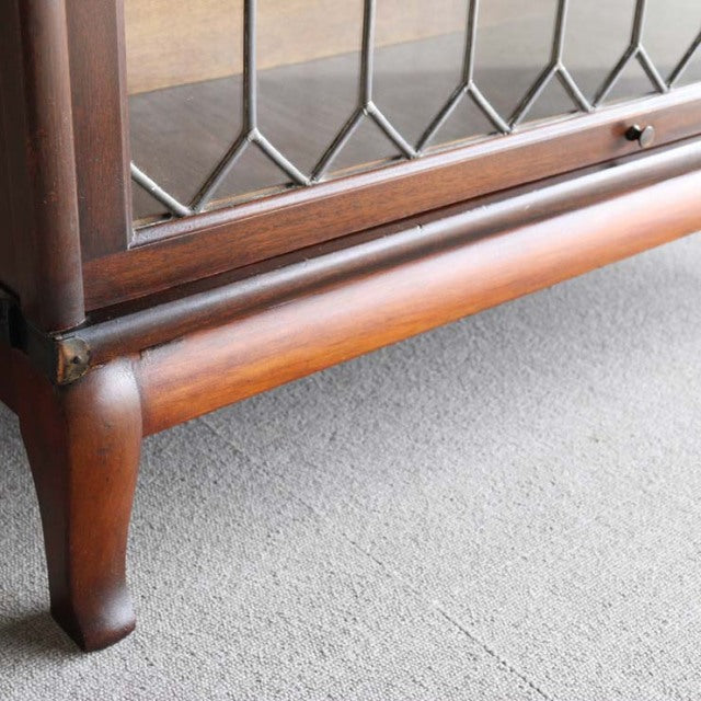 Vintage teak Globe Wernicke glass bookcase corner with British mid-century curved leg and textured wood grain.