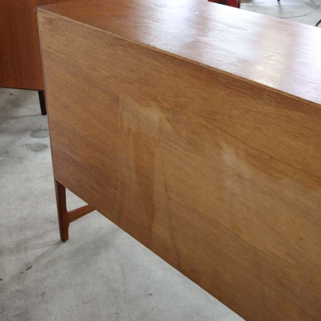 Vintage British mid-century teak sideboard by Nathan, smooth wood grain, tapered legs, rectangular form.