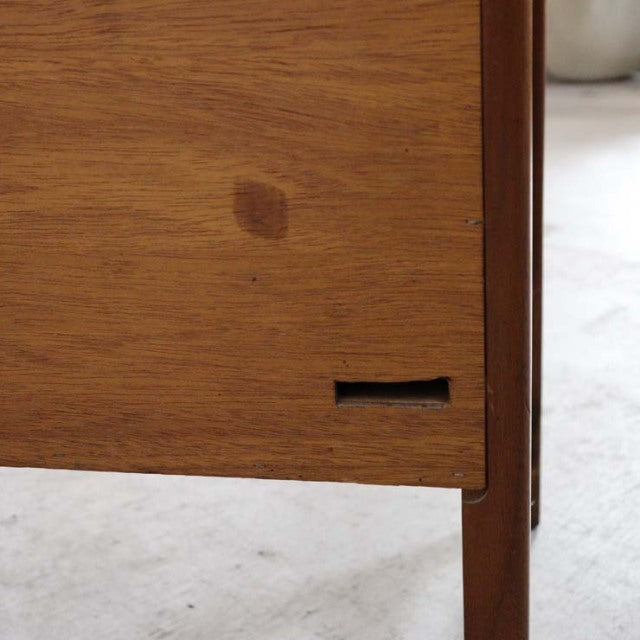 Close-up of vintage teak British mid-century sideboard corner showing wood grain and tapered leg detail from Nathan, Denmark .
