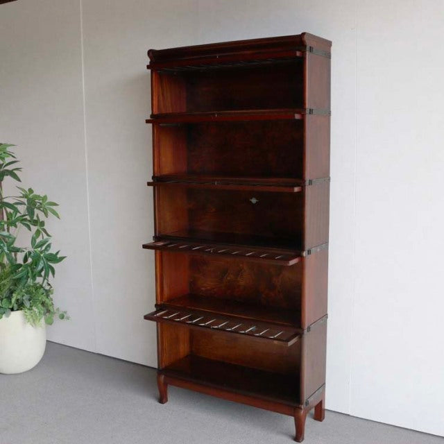 Vintage British Globe Wernicke teak glass bookcase with mid-century open shelves and wooden slatted drawers.