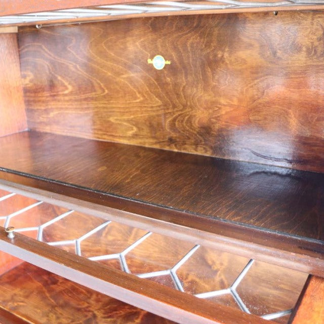 Vintage mid-century teak Globe Wernicke glass bookcase interior showing rich wood grain, brass hardware, and multiple glass.