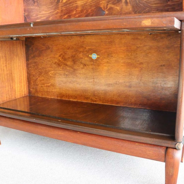 Vintage teak Globe Wernicke glass bookcase interior with rich wood grain and mid-century British design details.