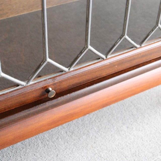 Mid-century British teak Globe-Wernicke glass bookcase door with geometric leaded glass and wood knob detail.