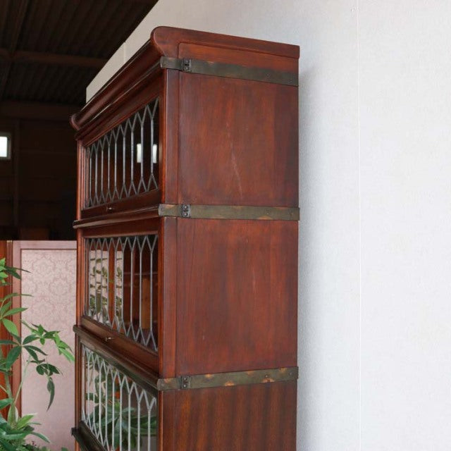 Vintage British teak Globe Wernicke glass bookcase with three stackable sections, mid-century design, intricate wood grain,.