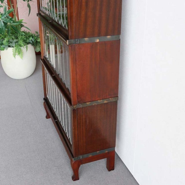 Vintage Globe Wernicke teak glass bookcase with British mid-century design, rich wood grain, and brass accents.