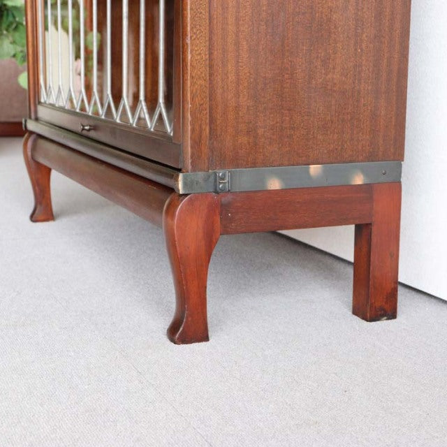 Vintage teak Globe Wernicke glass bookcase corner with mid-century British design, rich wood grain, and elegant cabriole leg .