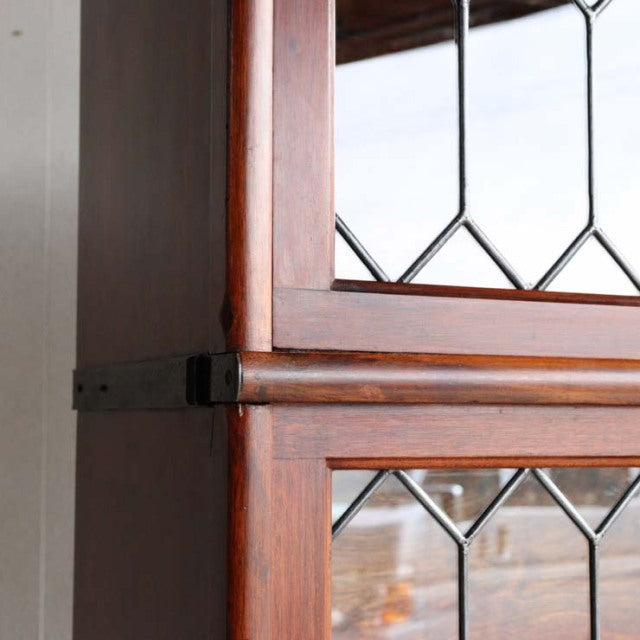 Vintage teak Globe Wernicke glass bookcase with mid-century British design, diamond-pane glass and rich wood grain detailing.