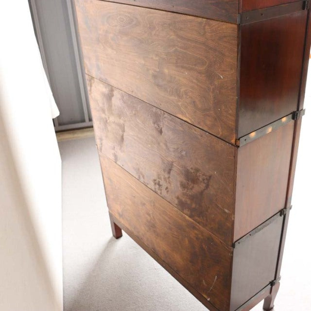 Vintage Globe Wernicke British mid-century teak glass bookcase with rich wood grain and slender legs.