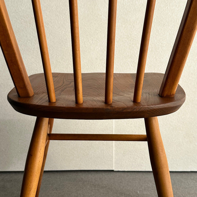 Vintage British mid-century Ercol hoop back chair with teak seat and spindled backrest.