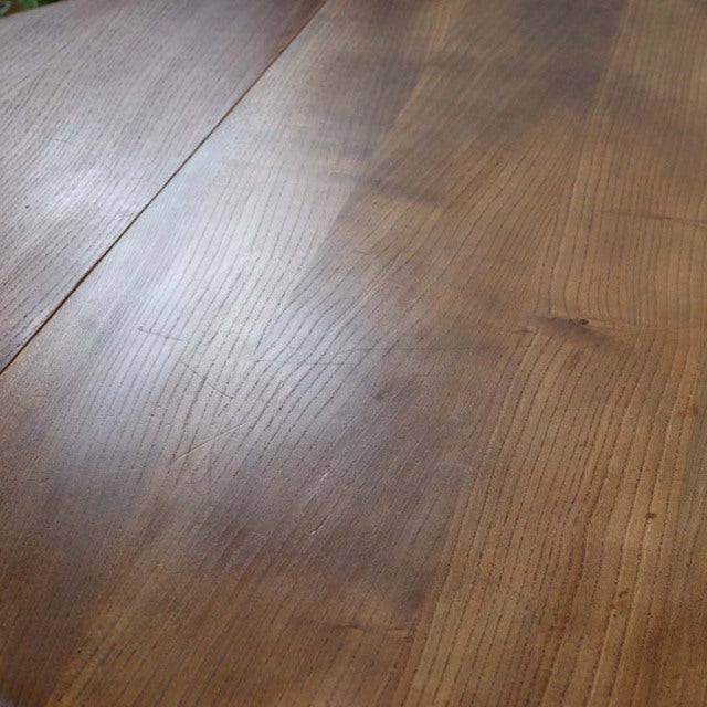 Vintage British Ercol mid-century teak dining table with smooth grain and drop-leaf design.