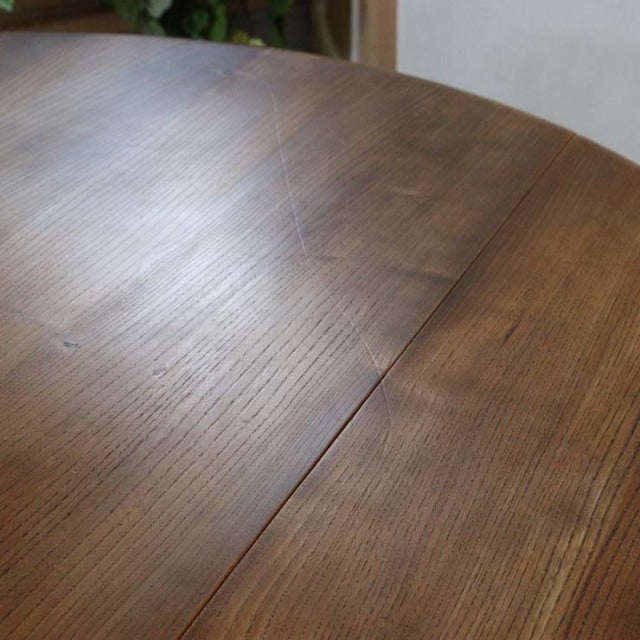 Mid-century British Ercol vintage teak dining table with rich wood grain and smooth drop-leaf design.