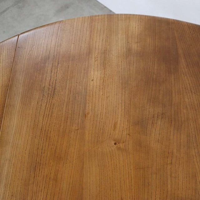Vintage British mid-century Ercol dining table in teak with smooth grain and rounded edges.