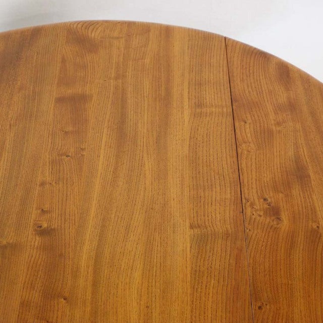 Mid-century British vintage Ercol dining table in teak with smooth drop-leaf top and visible wood grain.