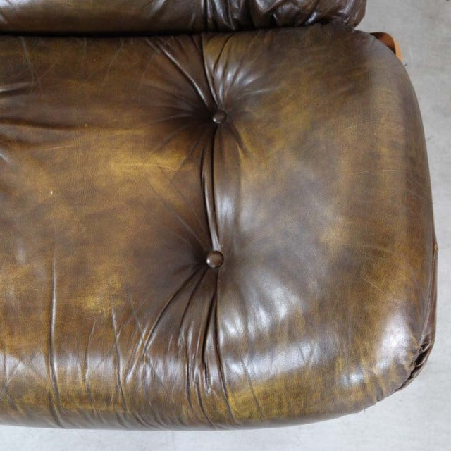 Vintage mid-century British leather armchair seat cushion with rich teak wood frame and deep button tufting.