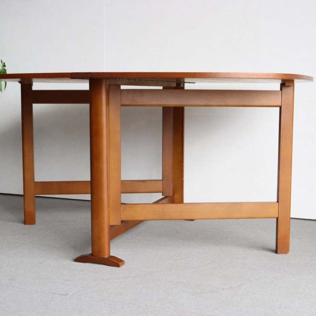 Vintage mid-century teak dining table with folding top, clean lines, and sturdy British-Danish design.