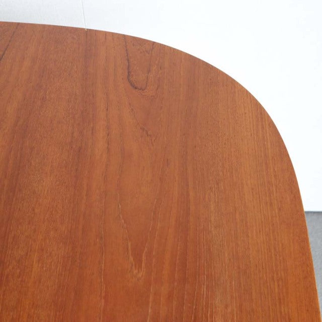 Vintage mid-century teak dining table with smooth rounded edge and rich wood grain, British-Denmark style.