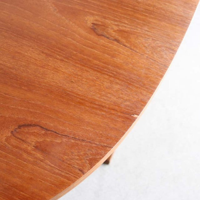 Vintage teak folding dining table corner showing smooth wood grain and mid-century British-Denmark craftsmanship.