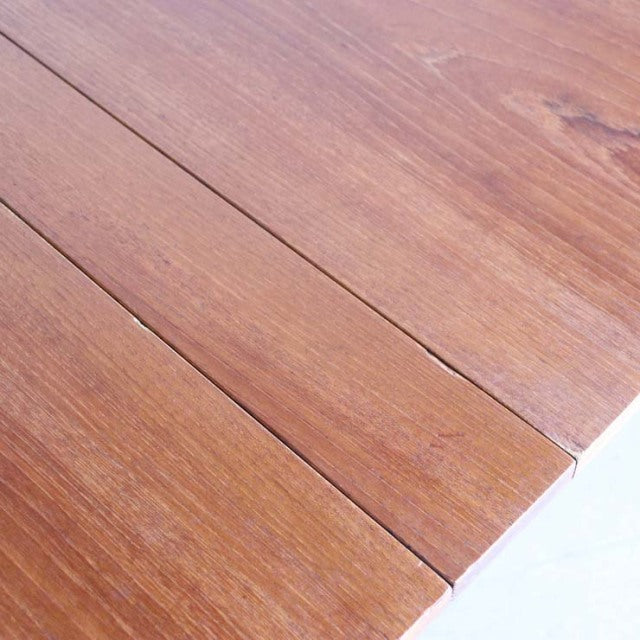 Vintage mid-century British teak dining table with rich wood grain and folding panels.